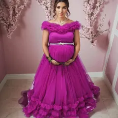 This off-shoulder magenta ruffle gown is a showstopper. The rich color and voluminous tiered ruffles create a glamorous look, while the sparkling belt highlights the empire waist, beautifully accommodating the baby bump.