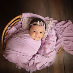 That precious, fleeting smile from a sleeping baby. Wrapped in a lovely lavender swaddle, this little girl's happy dream was a joy to capture.