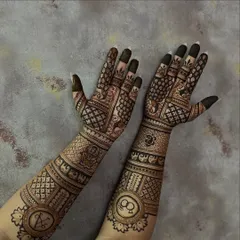 This design showcases a mix of symbolic elements for an engagement, including initials, rings, and auspicious elephants. The patterns are dense on the forearm and transition to more open work on the palm.