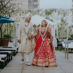 A candid shot of the newlyweds walking hand-in-hand after the ceremony. This is the kind of unscripted, happy moment we love to capture.