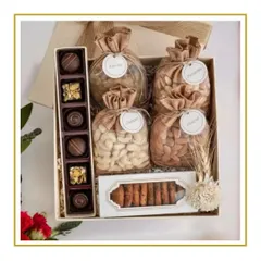 A classic Diwali hamper featuring a premium selection of dry fruits in jute potlis, artisanal chocolates, and cookies, presented in an elegant gift box.