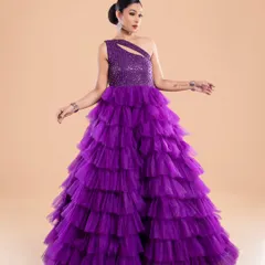 A full-length view of the purple layered gown, featuring a one-shoulder design and a sequined bodice. It's a popular choice for pre-wedding shoots and birthday parties.