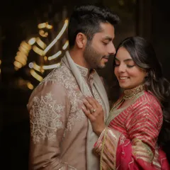 A quiet, happy moment shared between the couple. Their soft smiles and gentle touch create a portrait that is both intimate and full of warmth.