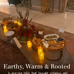 This grazing table was designed with an earthy, warm, and rooted theme. The rustic elegance of the wooden boards, candlelight, and rich colour palette brought a cozy and sophisticated feel to the celebration.