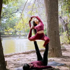 Acro yoga is about trust, communication, and strength. In this beautiful outdoor setting, we explore partner poses like this variation of Natarajasana, creating shapes that are both challenging and beautiful.