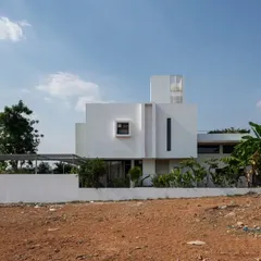 The west-facing elevation of the SAMAM house, showcasing its clean, minimalist geometric forms. The two-story bedroom block is strategically placed to shade the public living areas from the harsh afternoon sun, a key element of our climate-responsive design.