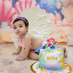 A closer look at our birthday girl next to her custom mermaid cake. These cake smash sessions are all about capturing the fun of turning one.