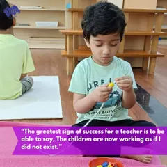 "The children are now working as if I did not exist." This quote from Dr. Montessori is the ultimate goal. This image of a child independently engaged in a threading activity perfectly illustrates a classroom where the teacher has successfully prepared the environment and can now step back and observe.