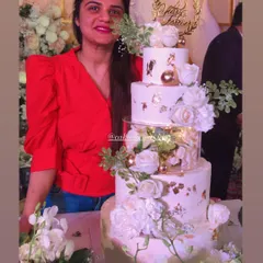Here I am with my first-ever five-tier cake. This white and gold anniversary cake was a dream to create, pushing my skills to new boundaries. It’s a blessing to be trusted with such important centerpieces for your celebrations.