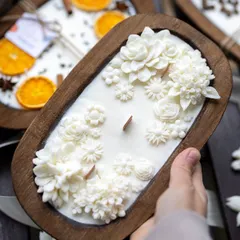 My boat candles are a bestseller for a reason. This one, filled with white wax flowers and featuring a wooden wick, is a beautiful and unique decor piece.