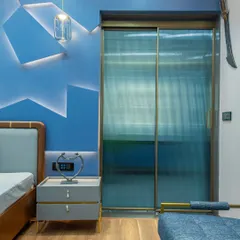 In this boy's bedroom, I used fluted glass sliding doors for the wardrobe. This adds a modern texture and partially obscures the contents, keeping the room looking tidy while adding a cool, contemporary design element.
