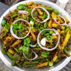 Kanghou, a popular savory stir-fried vegetable side dish from Manipur, garnished with fresh onions.