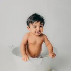 A big, happy smile from the tub. These splash sessions are always full of laughter and joy.