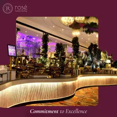 A wide-angle view of an elaborate, curved buffet counter at a grand event. Our commitment to excellence is reflected in every detail, from the strategic placement of dishes to the ambient lighting and decor.