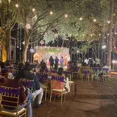 An enchanting outdoor wedding reception we catered at the Ecumenical Christian Center. We work with you to create a magical atmosphere with beautiful lighting and elegant seating that complements our delicious food.