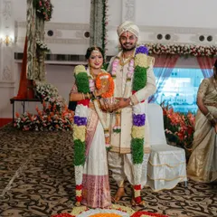 A full-length portrait of a lovely couple on their wedding day. I designed the groom's pure silk sherwani with hand embroidery to match the bride's traditional South Indian saree.