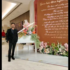 Posing next to a grand piano and floral setup at the event in Pune. Every detail of the venue adds to the magic of the evening.