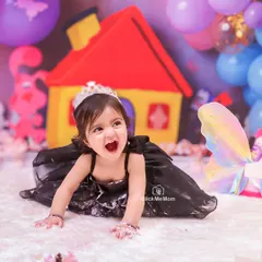 Let the mess begin. A first birthday cake smash is all about letting go and embracing the chaos, and this little princess's joyful expression says it all.