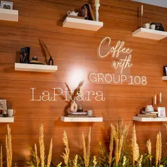 A closer look at the custom neon sign and styled shelves on our photo wall. The warm glow of the "Coffee with Group 108" sign added a modern touch to the rustic decor.
