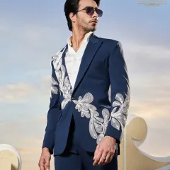 A modern navy blue suit with abstract white embroidery, perfect for a stylish groom's reception.