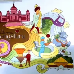 Another section of the Bengaluru-themed cafe mural, showing the Vidhana Soudha, Chinnaswamy Stadium, and a Nandi bull. It’s a visual story of the city.