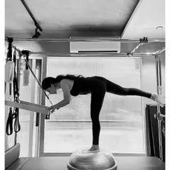 Pilates is the art of control. This exercise on the Reformer, using a BOSU ball, challenges stability and core strength, building the deep connection between mind and muscle.
