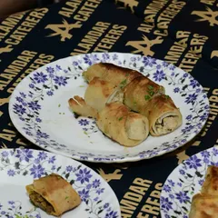 Our savory chicken rolls, perfectly cooked and plated, ready to be enjoyed by our guests.
