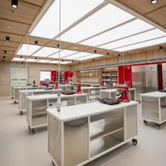A wide view of our New Delhi classroom, featuring individual workstations equipped with KitchenAid mixers and ample space for hands-on learning.