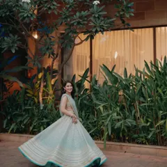 A beautiful shot of the bride twirling in her light blue lehenga, capturing a moment of pure grace and happiness during her Sangeet.