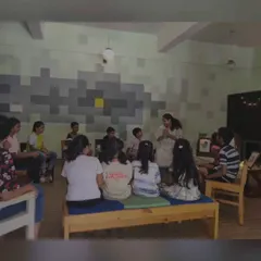 The kids are completely absorbed in a sea shanty tale. These interactive sessions help build listening skills and a love for stories.
