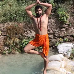 Performing Tree Pose in a natural, serene environment. Practicing yoga outdoors helps deepen the connection between the body, the mind, and the natural world around us.