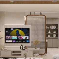 This living area features a custom TV unit and a fluted glass partition that elegantly separates the space without blocking light. The design balances open-concept living with defined functional zones.