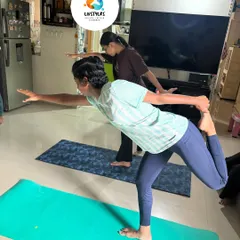 A young client practices Natarajasana (Dancer's Pose), a beautiful balancing pose that improves focus, stability, and flexibility.