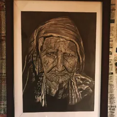 A powerful and detailed charcoal portrait of an elderly woman, focusing on the expressive lines of her face. This is a framed A3 artwork.
