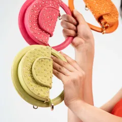 My Candy Floss mini bags are all about having fun with fashion. This image shows a few of the vibrant, playful colours available, each with a unique circular handle and delicate stud detailing.