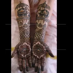 This bridal mehendi combines traditional motifs like elephants and doli with a bold mandala design on the palm for a modern yet classic look.