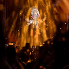 I use dramatic lighting and smoke effects to create a divine and powerful atmosphere. This shot from the Kalachowkicha Mahaganpati Aagman captures the idol emerging through golden light, a moment of pure devotion that my production is designed to enhance.