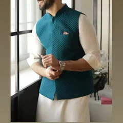 A teal quilted Nehru jacket paired with a white kurta. This is a stylish and comfortable option for festive gatherings or casual events.