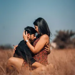 A tender embrace in a golden field, showcasing a moment of quiet connection. Our focus is on capturing the genuine emotion between you and your partner during your portrait session.