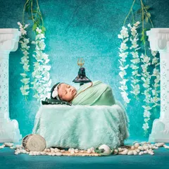 A grand and divine Maha Shivratri setup. The newborn rests peacefully between two majestic white pillars, with a Trishul in the background, creating a powerful and artistic spiritual portrait.