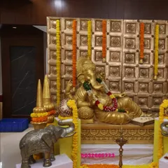 A side view of the Ganesha setup, showing the ornate golden backdrop and marigold garlands. This type of decor is ideal for celebrating festivals like Ganesh Chaturthi or Diwali in a corporate setting.