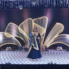 Taking center stage in a stunning blue lehenga to kick off a night of music and dance. The right stage presence sets the tone for the entire Sangeet event.