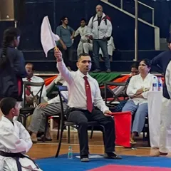 Here I am officiating a kumite (sparring) match at a JKA tournament. As a certified judge, I am responsible for ensuring that contests are conducted safely and according to the strict rules and high standards of the Japan Karate Association.