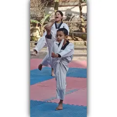 Kick high and fly to the sky. Our young students practice their front kicks, building the muscle memory and form needed for powerful strikes.