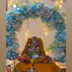 A beautiful floral arch for a home Ganpati setup. We used artificial flowers in shades of blue and white to create this backdrop, with string lights adding a touch of sparkle to the celebration.