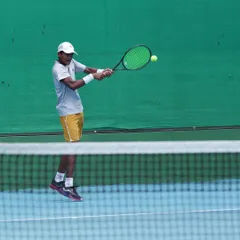 The focus and technique required for a perfect backhand shot. This action shot shows the result of countless hours of on-court drilling and physical conditioning.