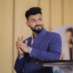 A client commanding the stage in our custom-made blue pinstripe suit. The fit is tailored to allow for movement and presence, proving that bespoke is the ultimate choice for professionals.