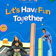 Let's have fun together. Here, a family enjoys different activities, with a young adventurer tackling the climbing pillars while her family bounces below.