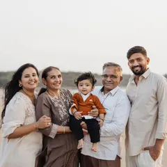 A wonderful multigenerational family photo taken on the beach to celebrate a first birthday.