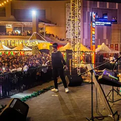 On stage at Phoenix Marketcity, with a huge crowd gathered in the open-air venue. This shows our experience in handling large-scale public events and turning a shopping plaza into a concert arena.